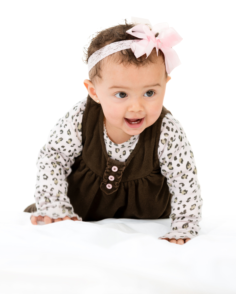 Beautiful baby girl crawling - isolated over a white background